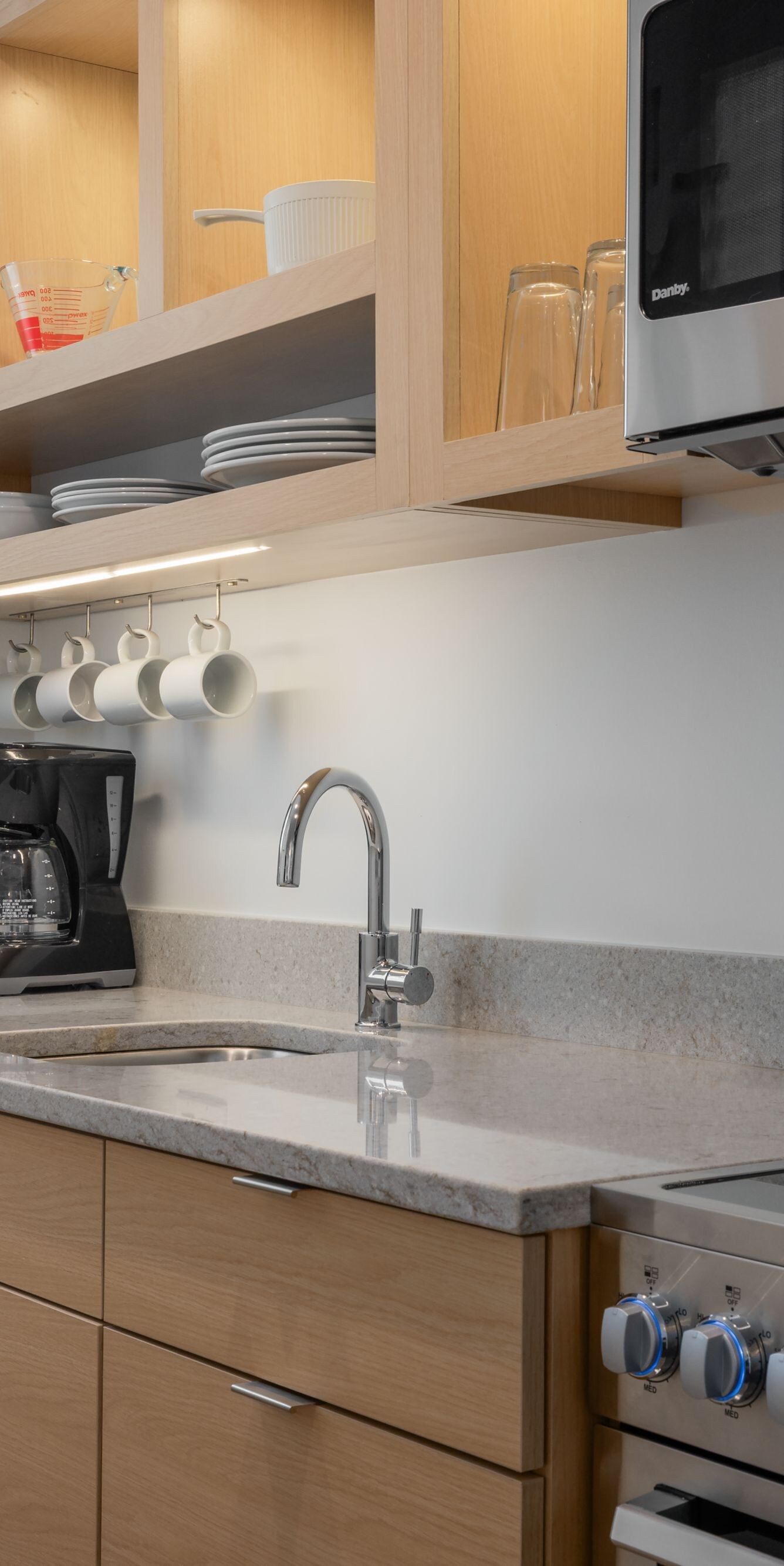 Suite kitchen with stove, sink, cabinets