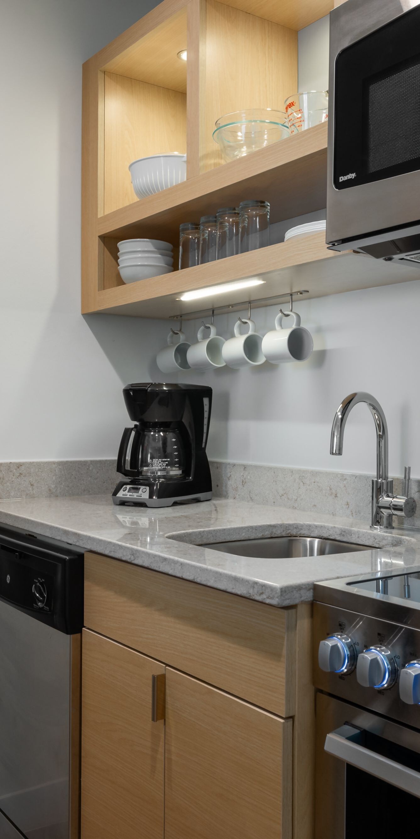 Suite kitchen with stove, sink, microwave