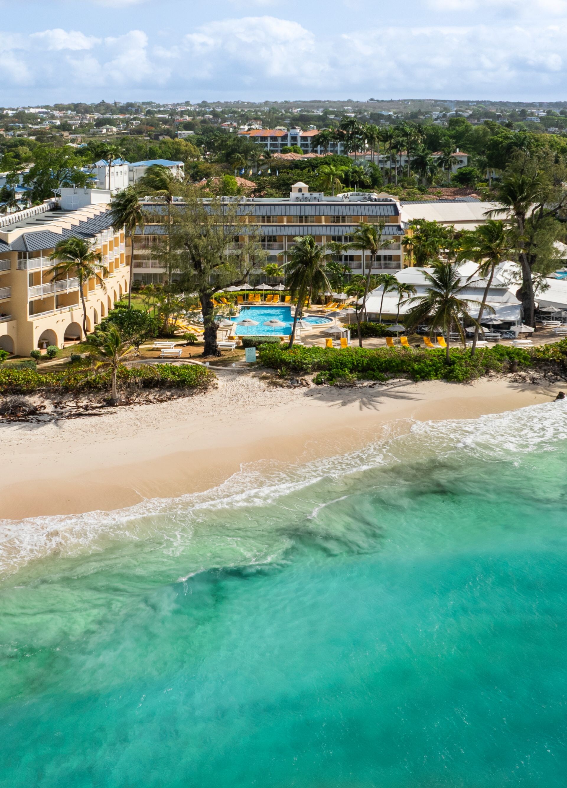 Beachfront resort beside turquoise water.