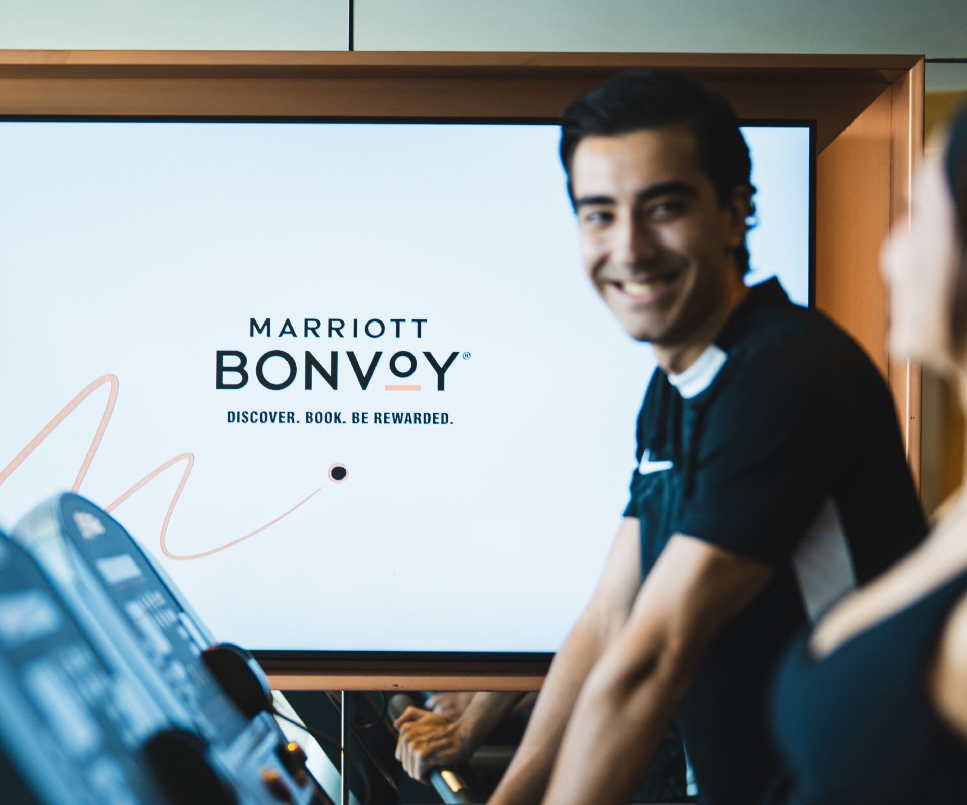 Guests exercising on treadmills in a hotel gym