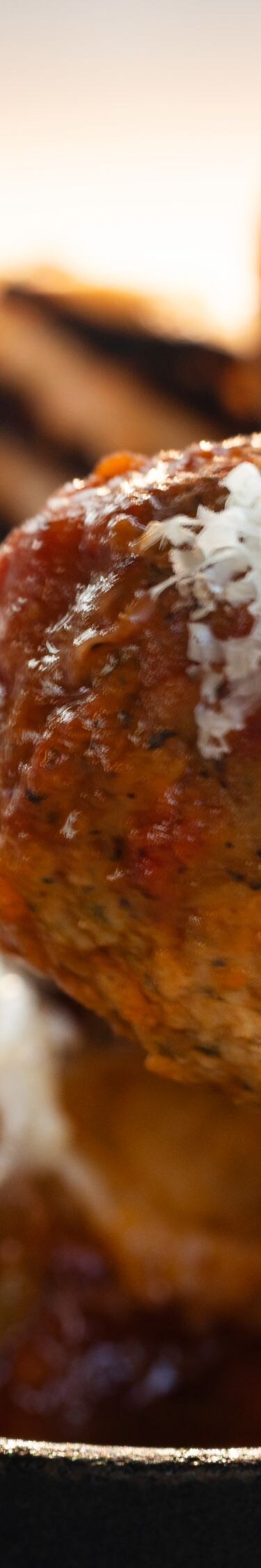 Meatball on fork with grated cheese
