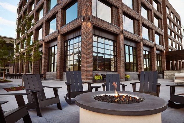 Fire pit with chairs outside hotel