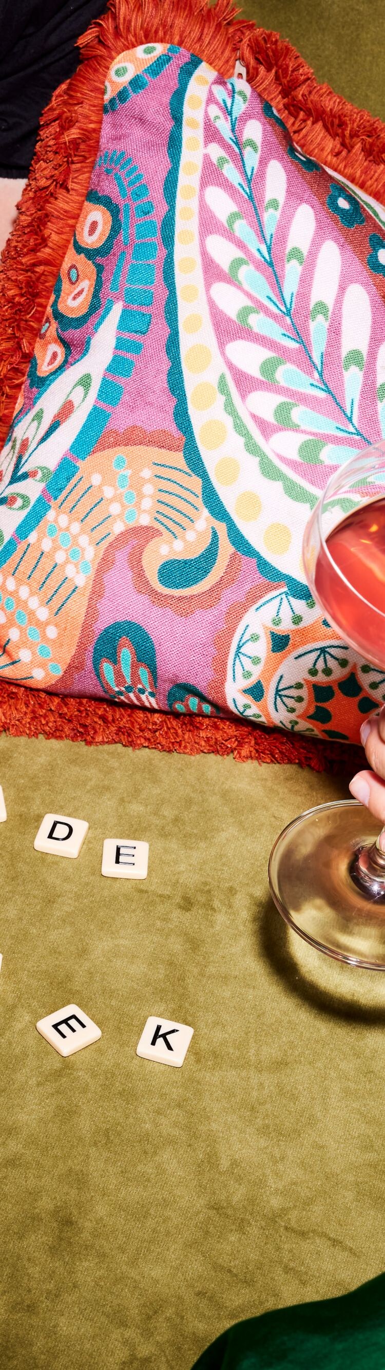 Two ladies lounge with cocktails, scrabble letters
