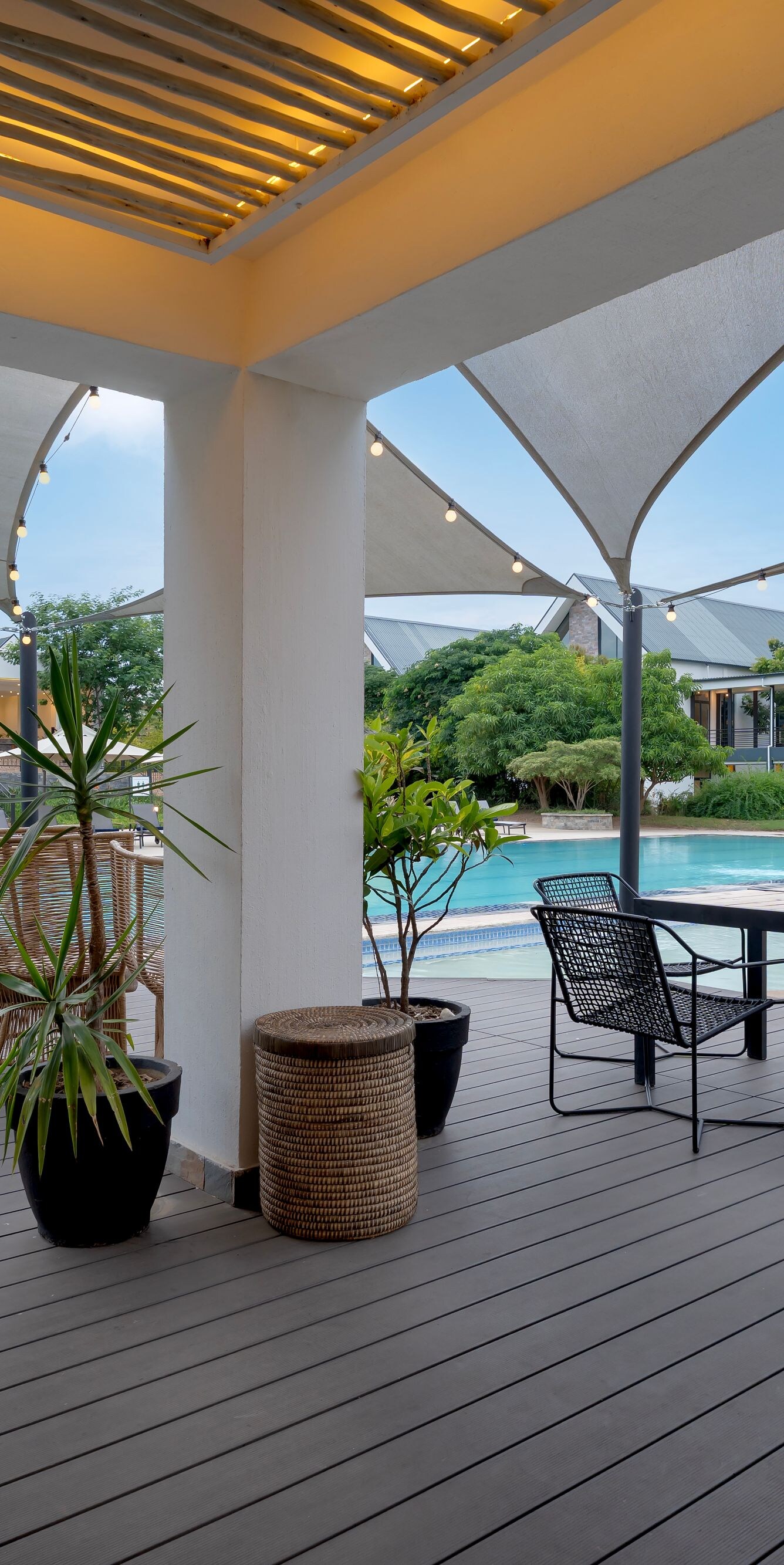 Outdoor patio with pool seating and shade sails