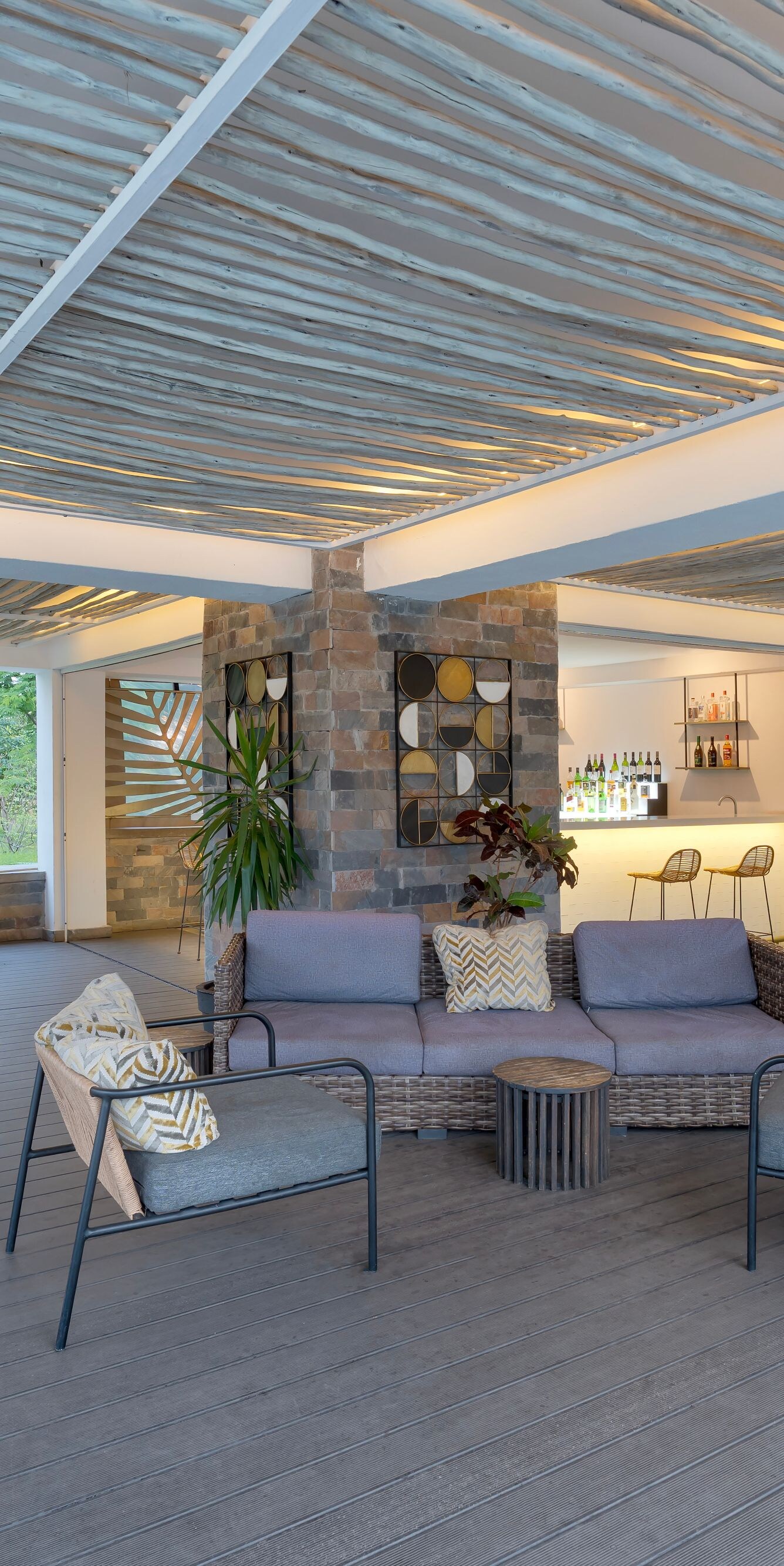 Covered outdoor lounge with bar and seating