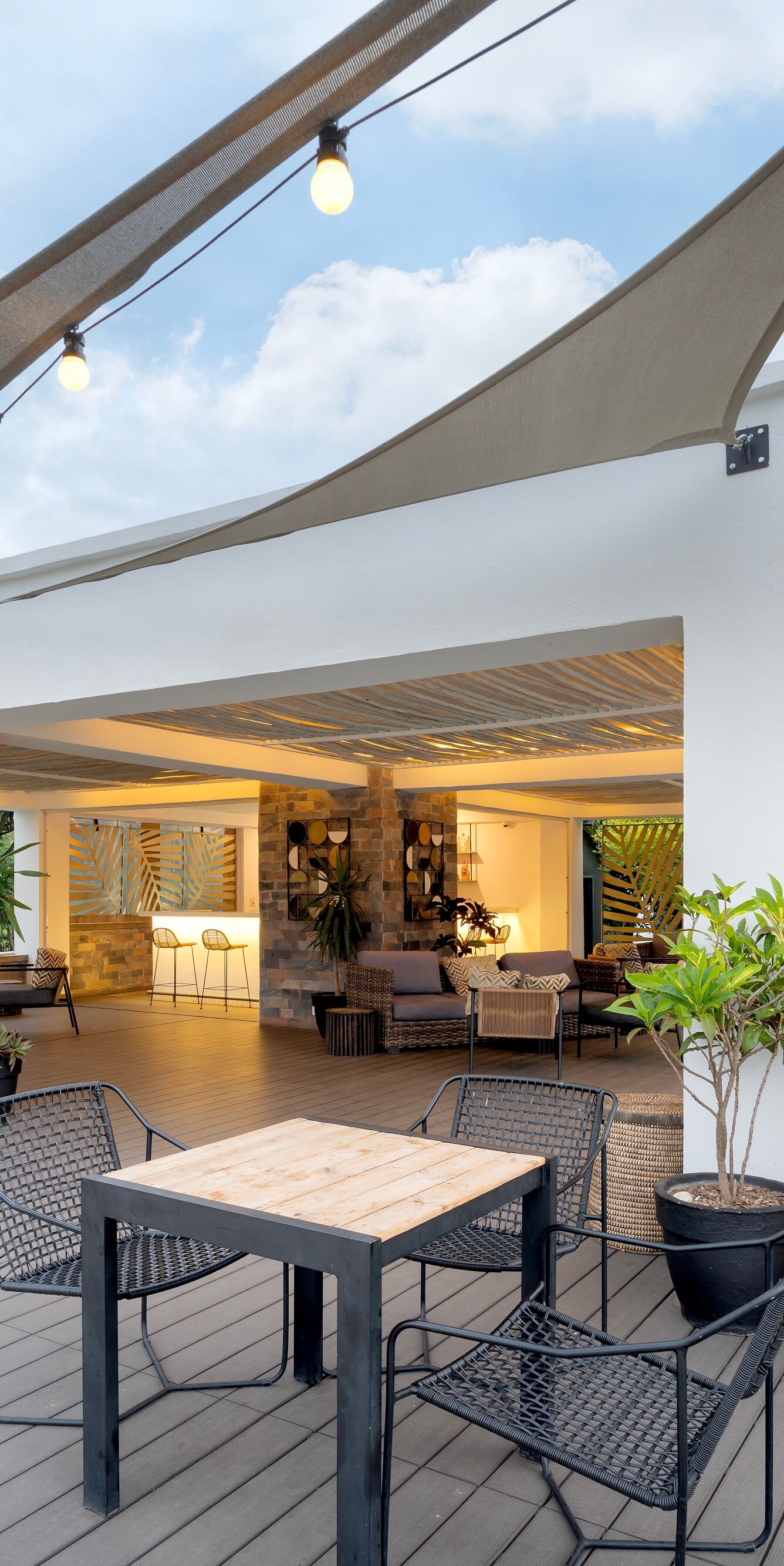 Outdoor lounge with seating shade sails and bar