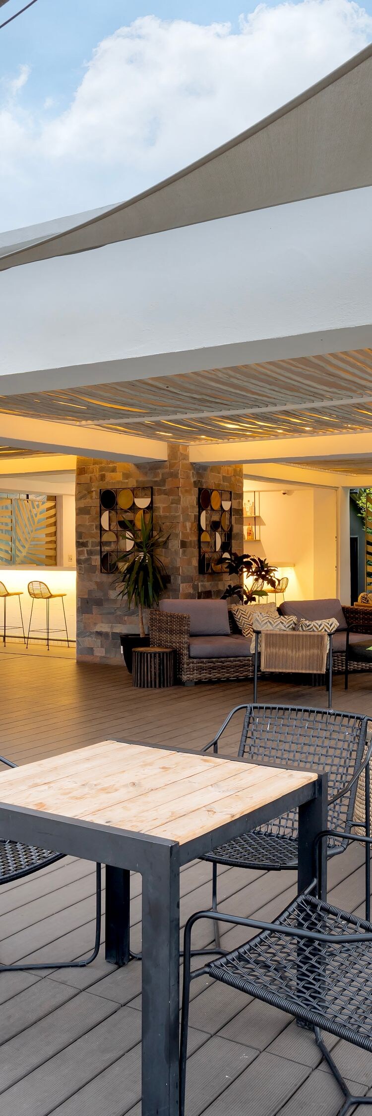 Outdoor lounge with seating shade sails and bar