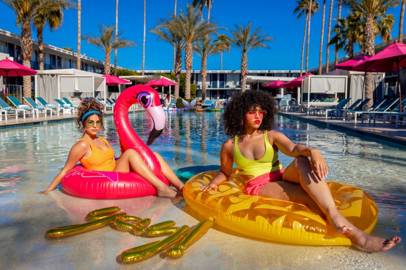 two fashion girl on pool floats on the pool