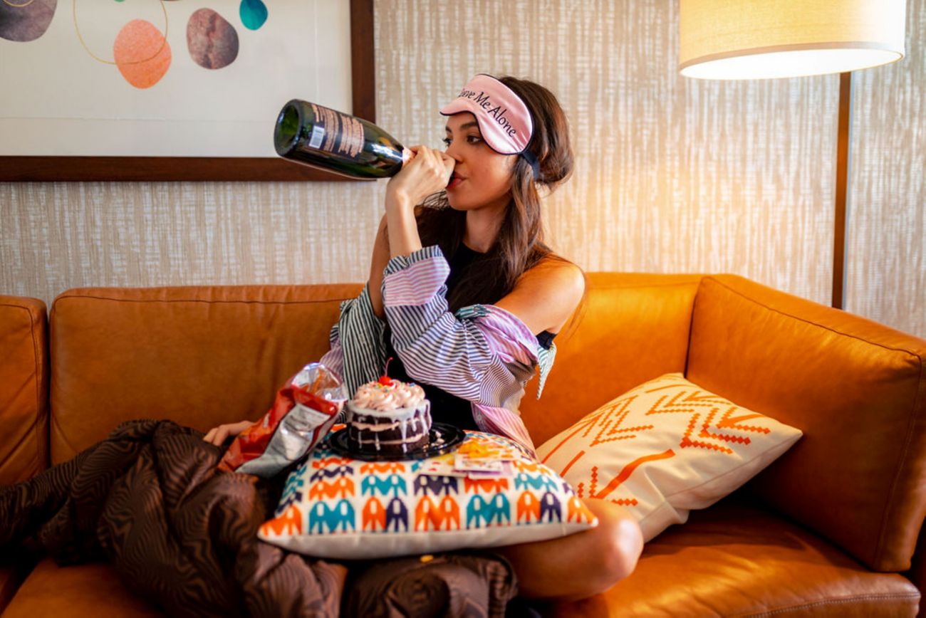 Lady on sofa with food drinking champagne