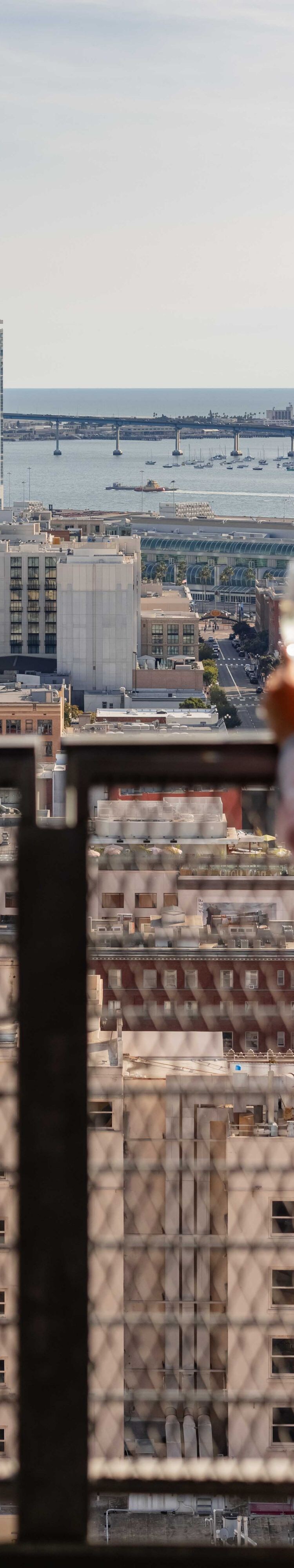 woman in robe with champagne on hotel balcony