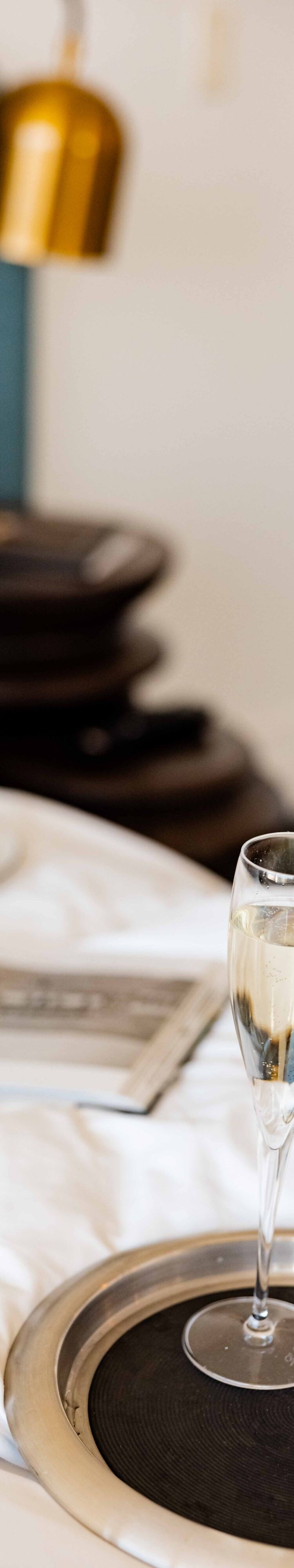 champagne and pastries on guest bed