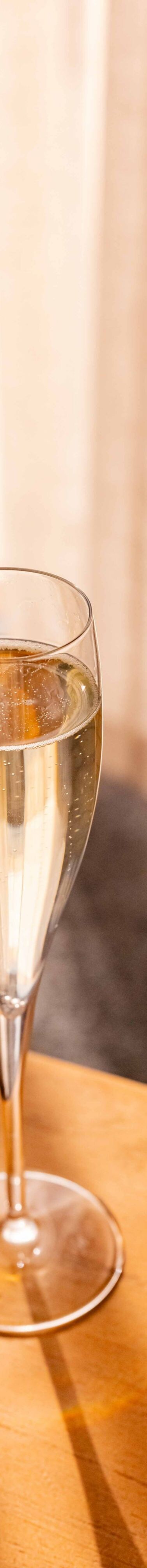 Glass of champagne on a table in a guest room