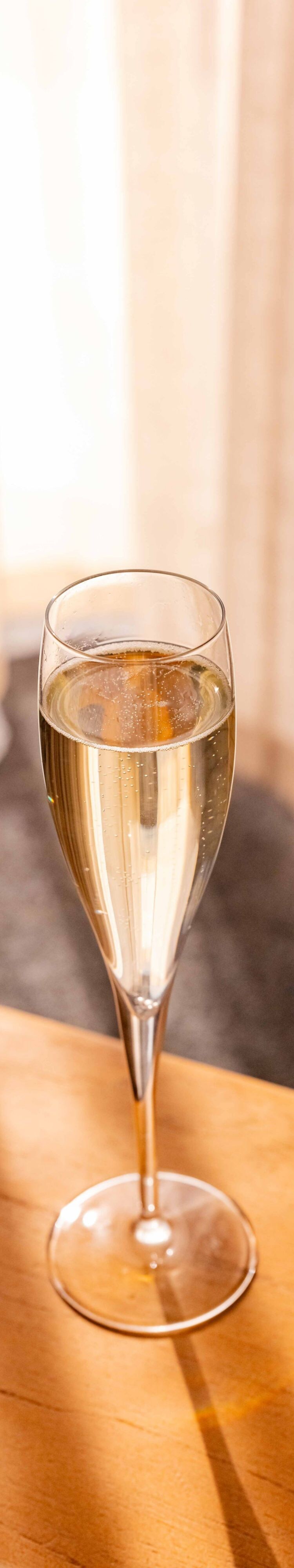 Glass of champagne on a table in a guest room