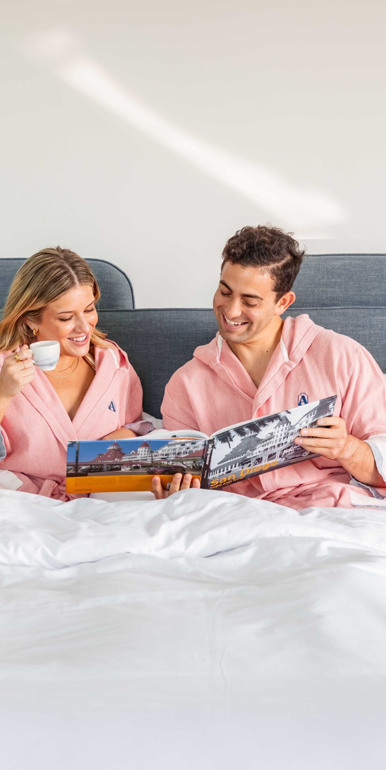 man and woman sipping espresso in bed