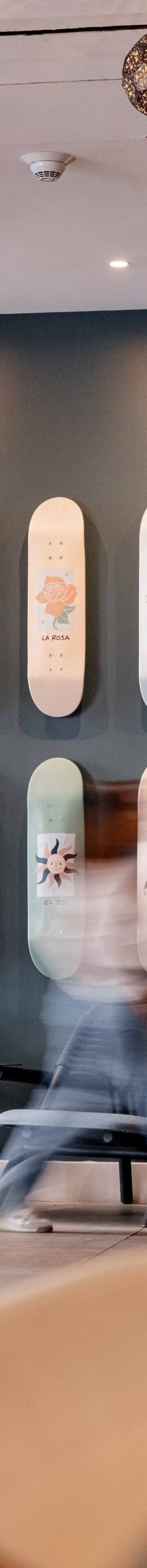 guest walking past skateboard art feature wall