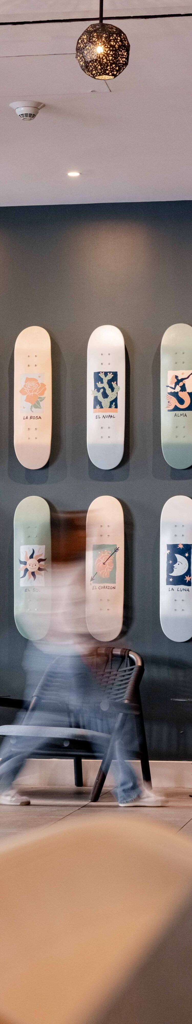 guest walking past skateboard art feature wall