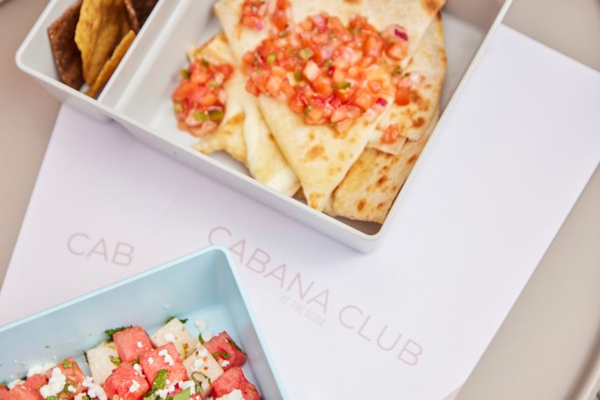 Chips and dips in dishes above a Cabana Club menu