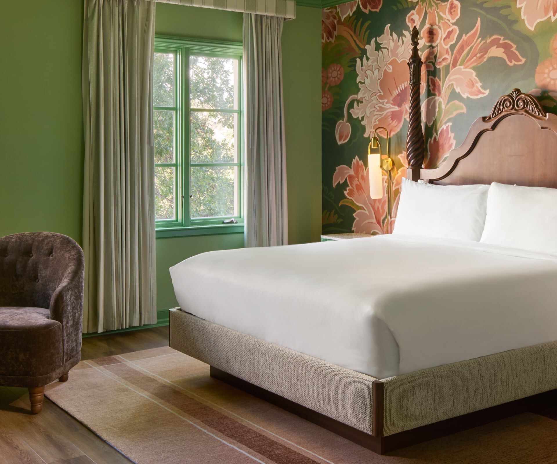 King bed with two chairs, table, and couch. 