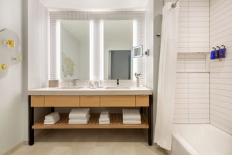 Guestroom bathroom with 2 sinks and tub.