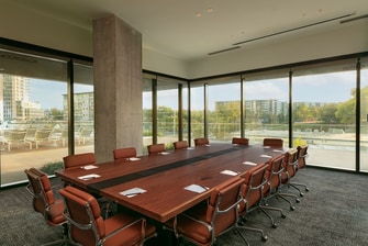 Conference table with floor to ceiling windows.