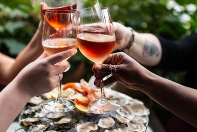 Friends cheers their glasses over Fresh Oysters