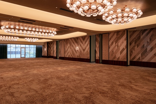 Clean and clear ballroom with chandeliers.