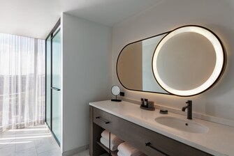Bathroom vanity with mirror and shower.