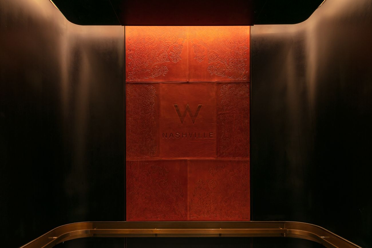 Etched leather panel inside elevator cab. 