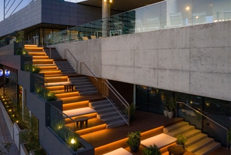 Side of hotel with illuminated exterior staircase.