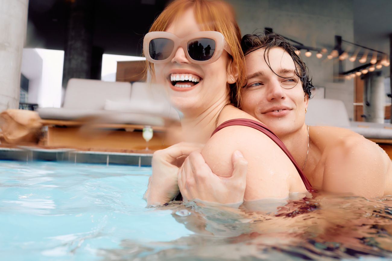Man and woman hugging in pool. 