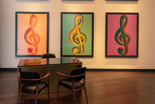 Concierge desk with music note artwork.
