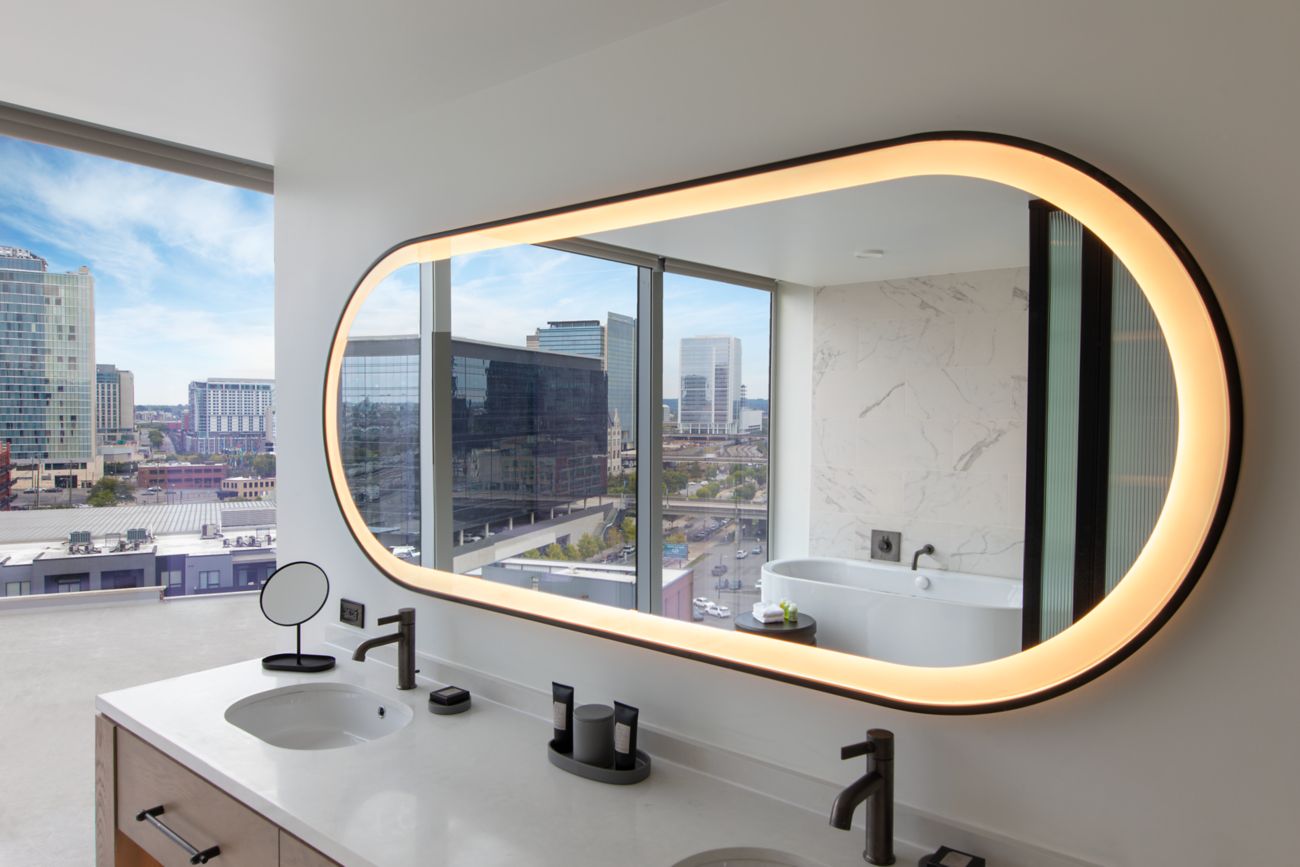 Mirror with reflection of city skyline.