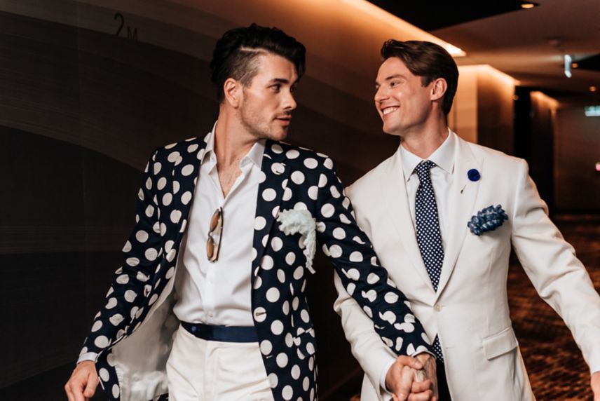 Two grooms holding hands