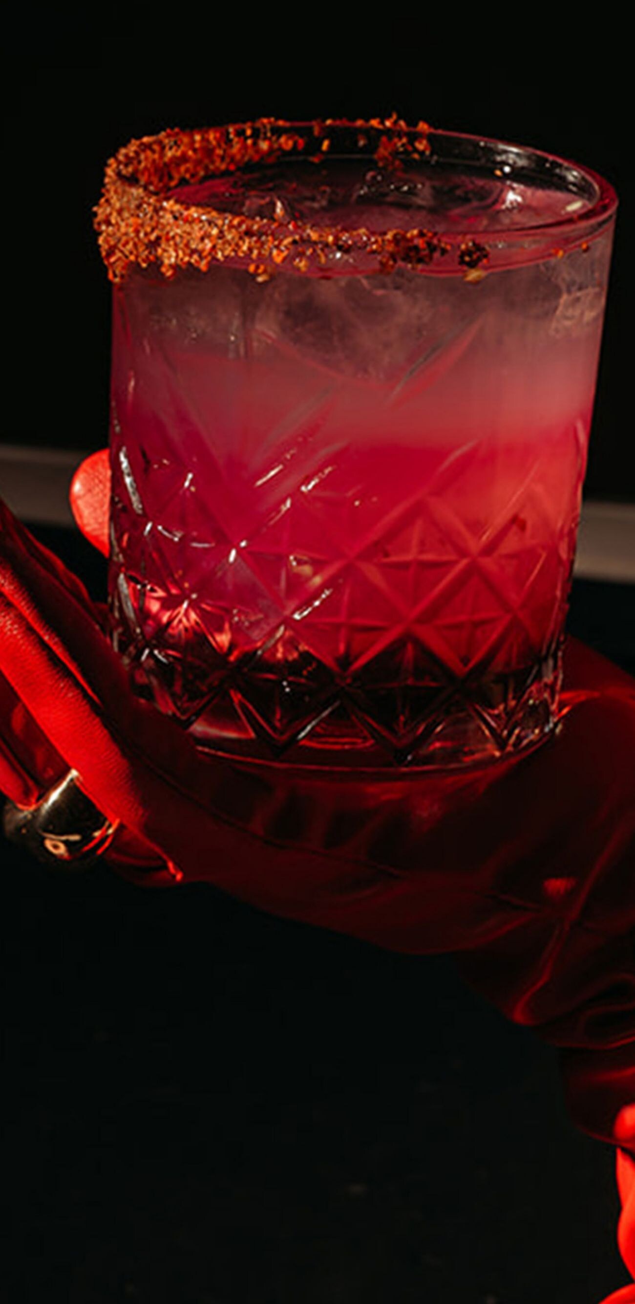 Cocktail in red glove with chili rim
