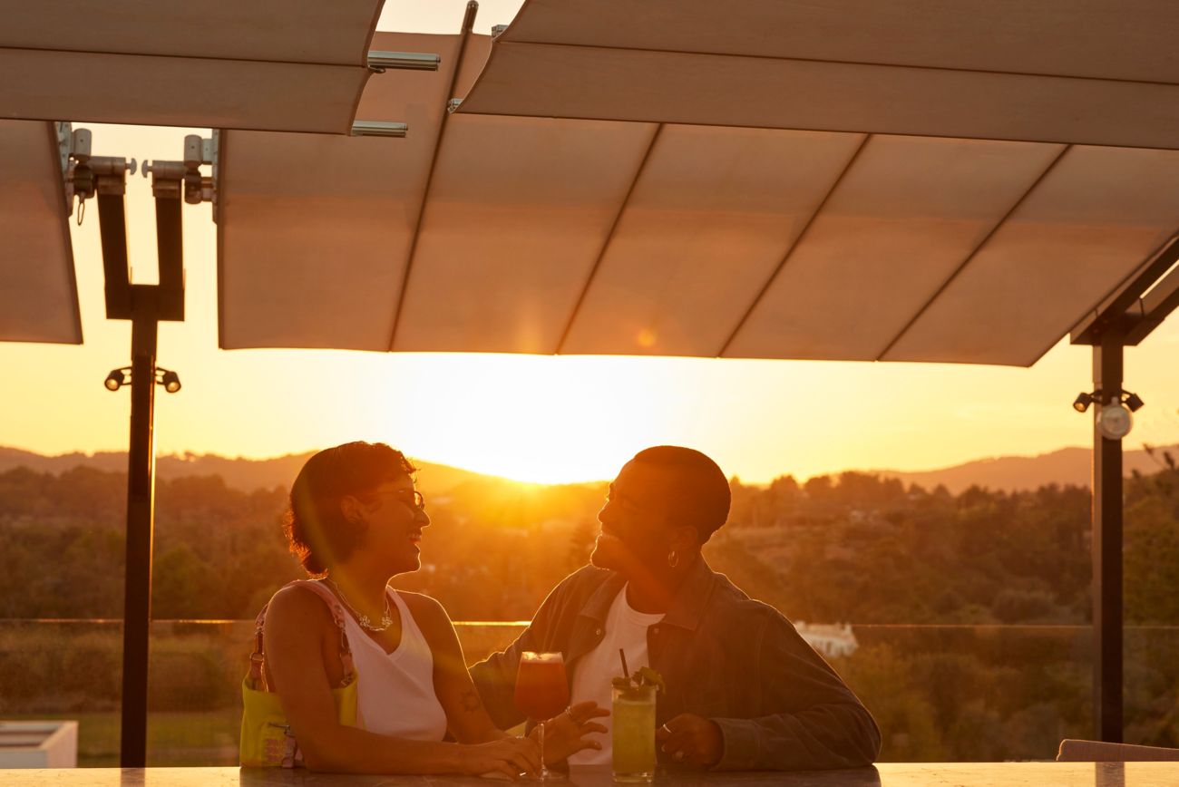 Sunset on a rooftop bar with two guests