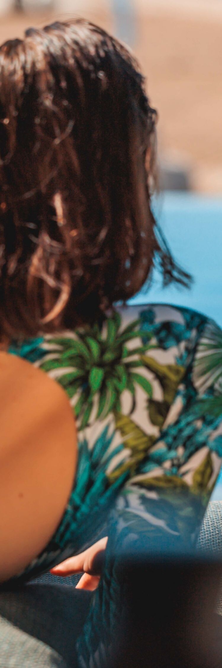 woman's back poolside cocktail
