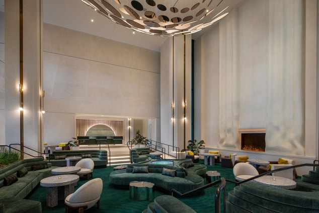 Lobby with view of green velvet seating, fireplace