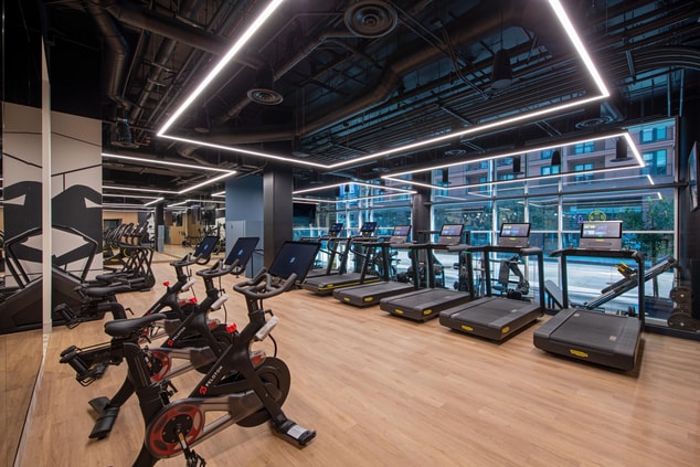 Corner view of gym featuring peloton bikes, treadm