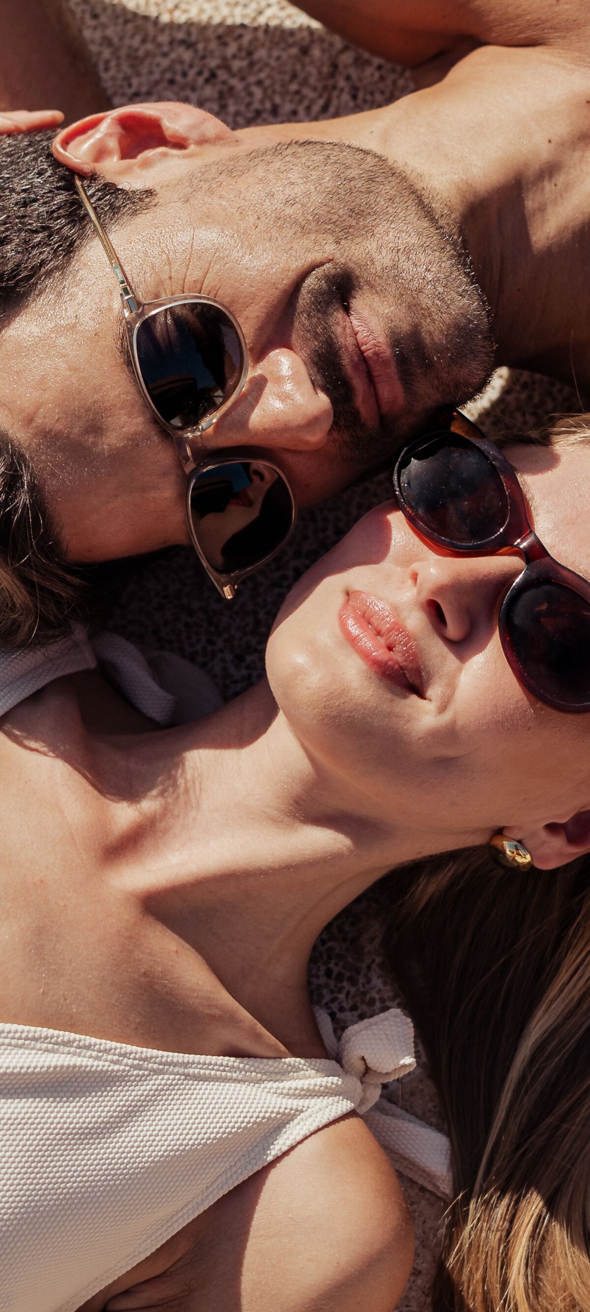 Couple laying by the pool