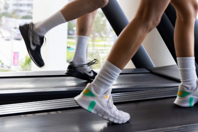 two adults running on treadmill