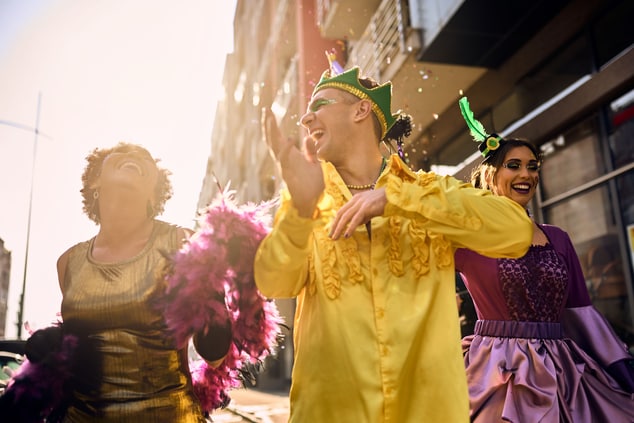 Cheerful friends dancing on Brazilian carnival par
