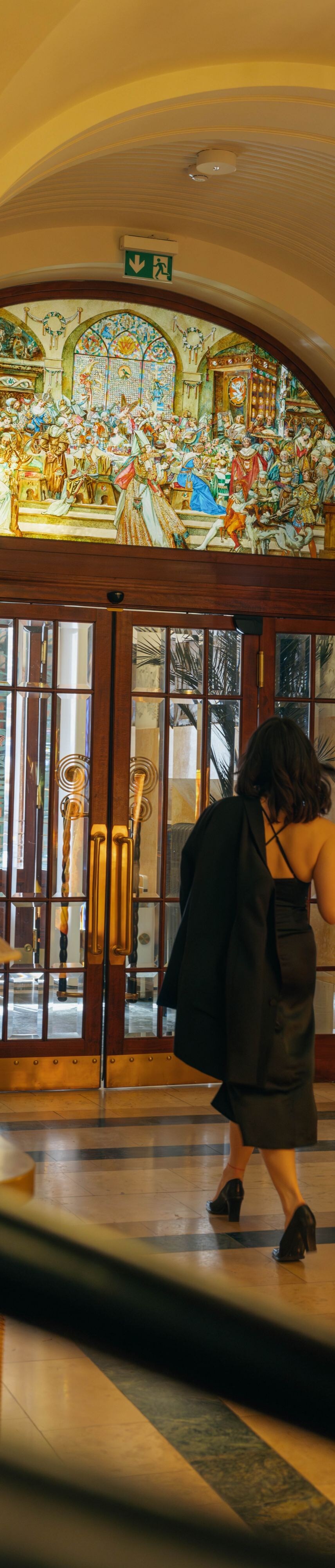 Two guests leaving through the main entrance.