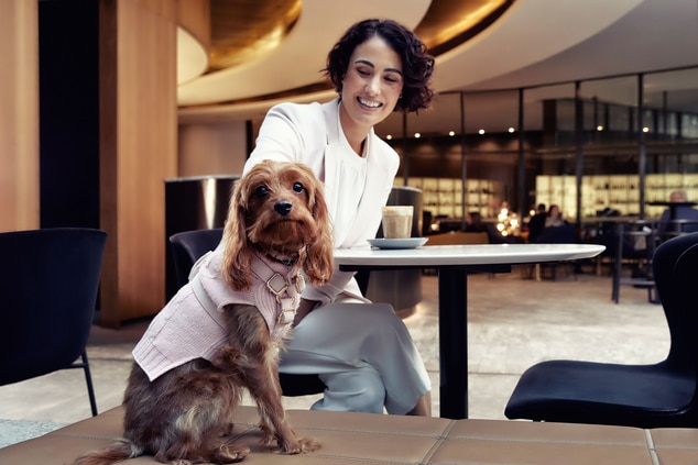 Woman and dog at a restaurant table