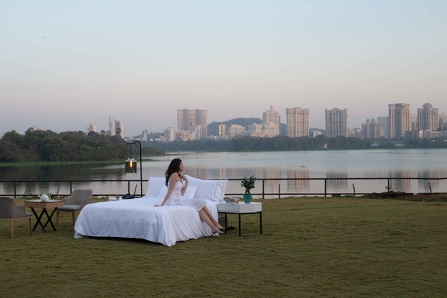 Person in bed set up by the lake. 