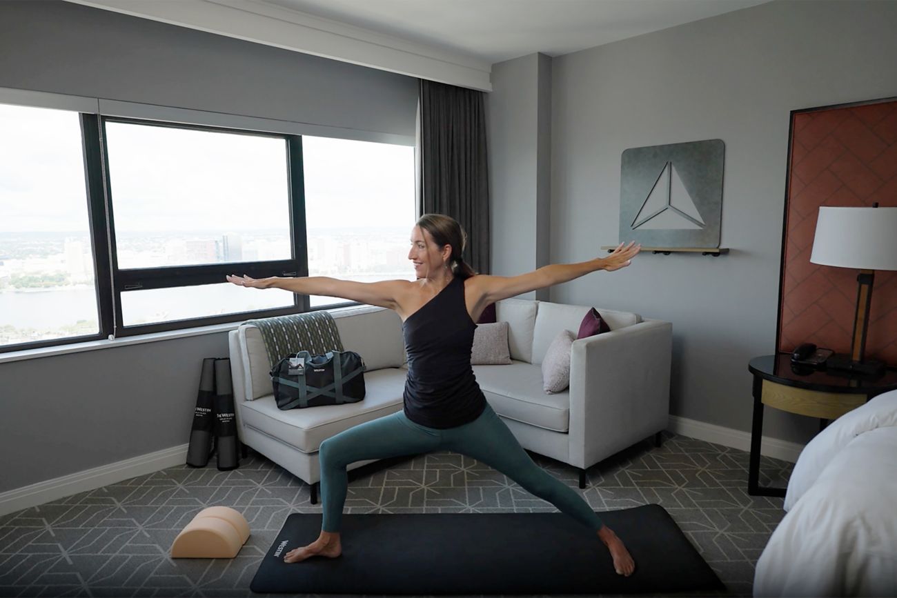 Woman doing a yoga pose in hotel room