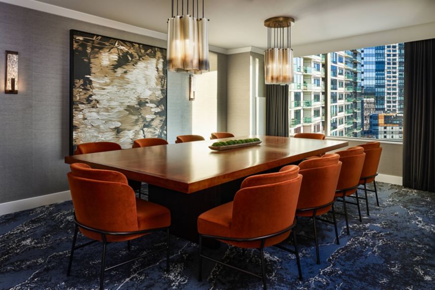 Bellevue suite boardroom with 10 orange chairs