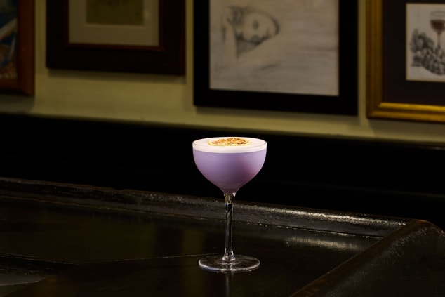 Purple cocktail in a coupe glass