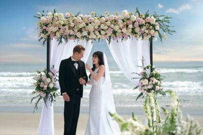 Couple at beach wedding ceremony