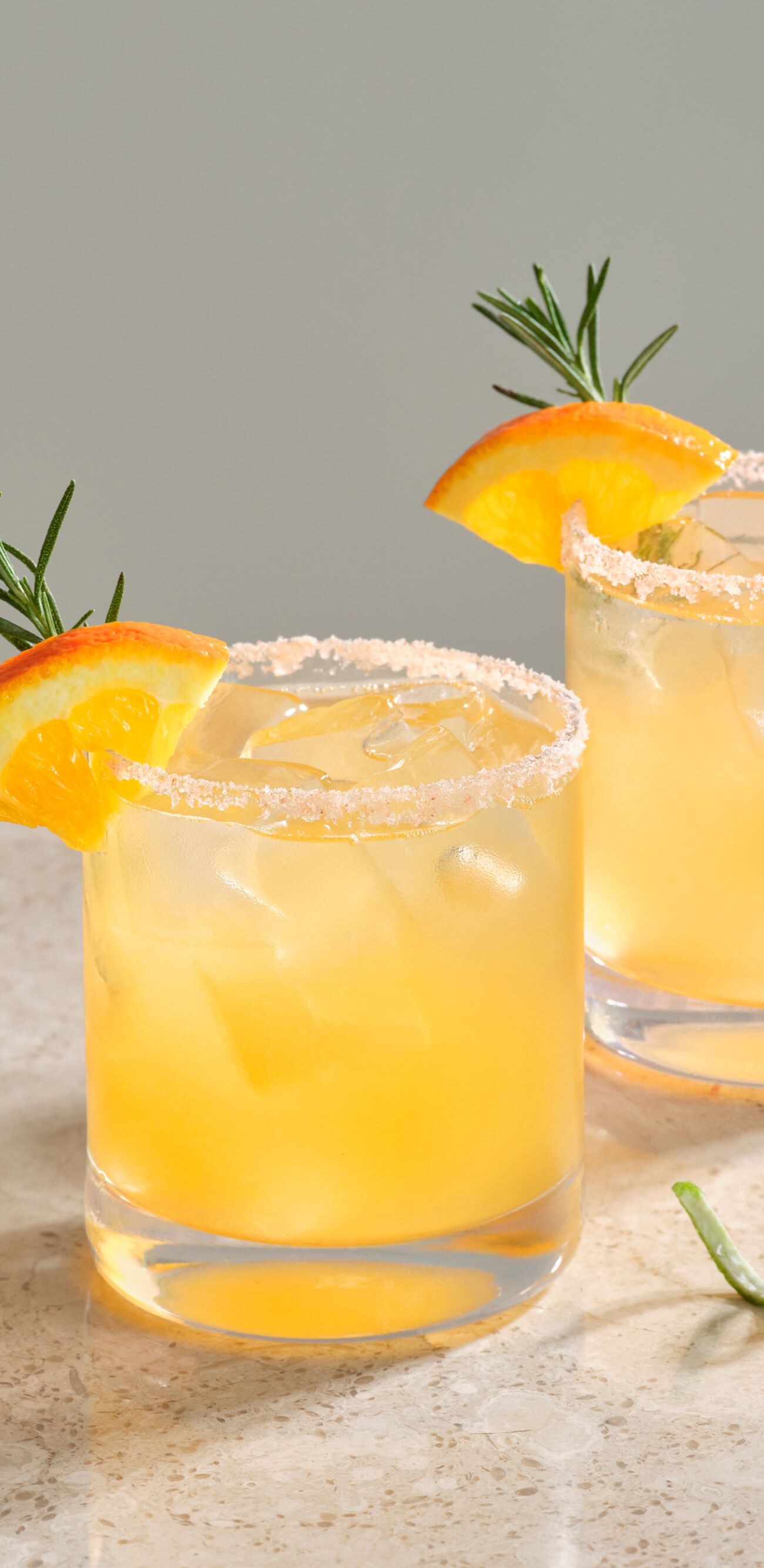 Two cocktails: citrus, floral foam, fruit garnish,