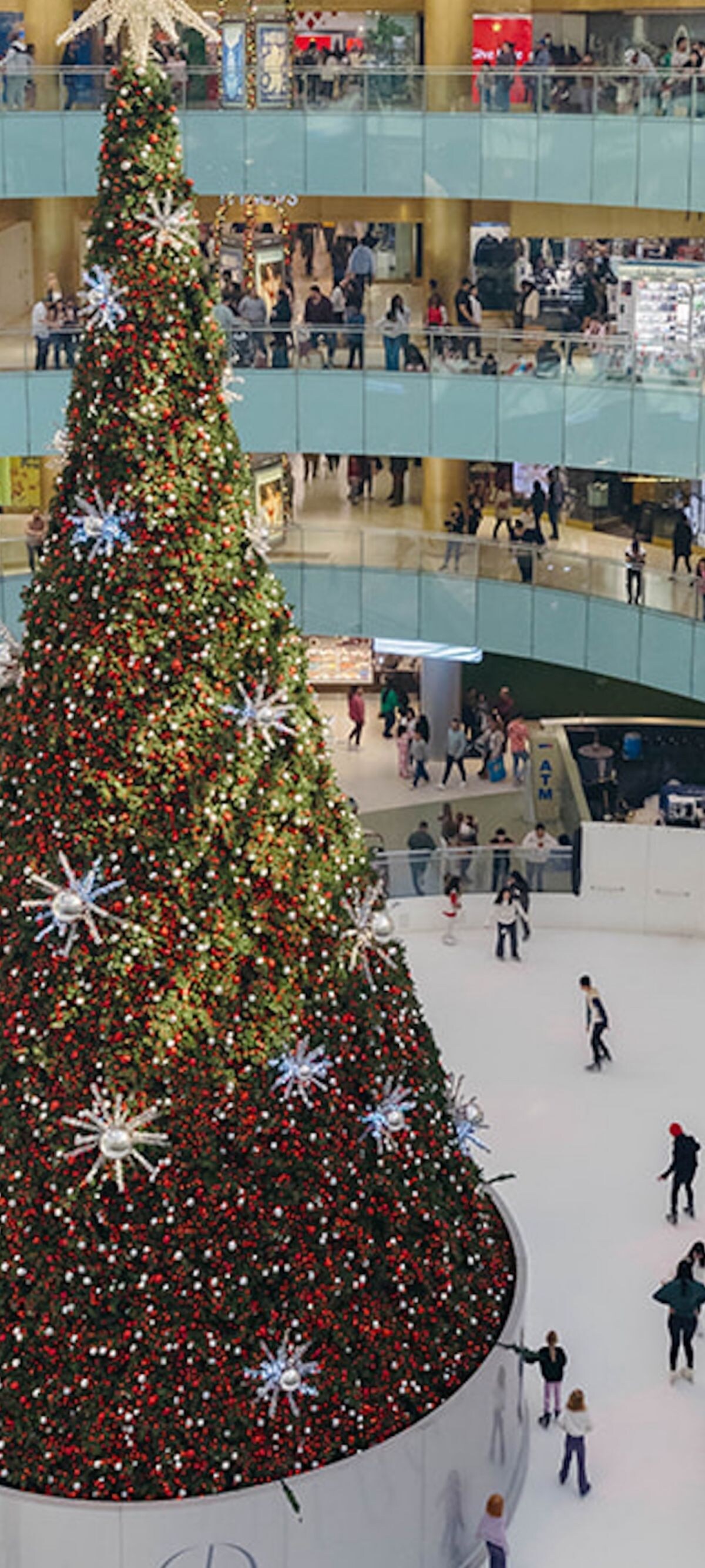 Tall Christmas tree with ice skaters at Galleria D